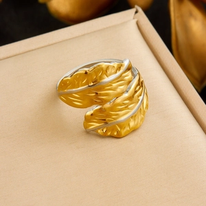 Detailed macro view of a gold leaf-shaped adjustable ring with delicate vein texture