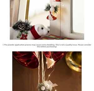 Close-up of red Christmas bells with pine needles, cones and a white teddy bear ornament