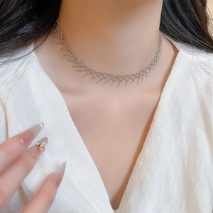 Detailed view of silver mesh lace choker necklace on neck with delicate geometric weaving