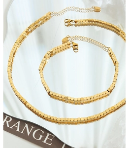 Detail of 18K gold-plated square bead chain necklace and bracelet jewelry set