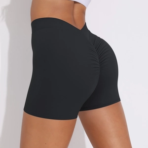 Detail of high waisted black scrunch yoga shorts showing peach lift effect and stretch fabric