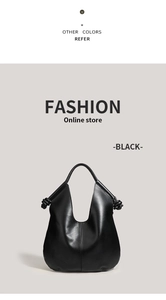 Detail of minimalist black leather hobo bag with unique knotted strap and sleek finish