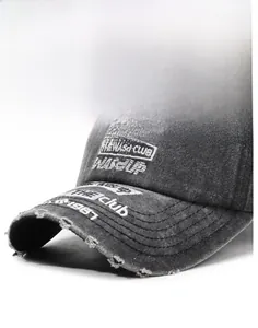 Detail of vintage washed grey baseball cap with distressed holes and 3D WASD CLUB embroidery