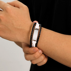 Detail of multi-layer woven leather bracelet with customizable blank metal nameplate