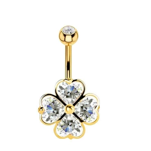 Detail of gold belly ring with clover pendant made of heart-shaped clear zircons
