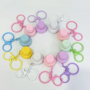 Top view of colorful bell-shaped fidget toy keychains arranged in a neat circular pattern