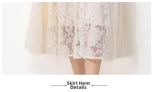 Détail de la broderie florale en dentelle et de l'ourlet double épaisseur de la robe
