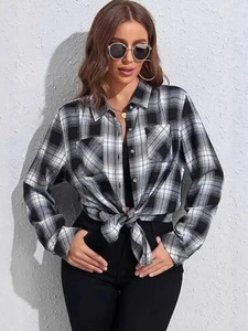Classic black and white plaid flannel shirt with lapel collar and front pockets tied at waist
