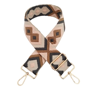 Detail of adjustable jacquard replacement strap with geometric pattern and gold hardware