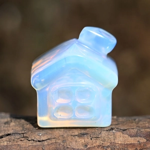 Macro shot of an opalite house ornament placed on natural tree bark with soft lighting