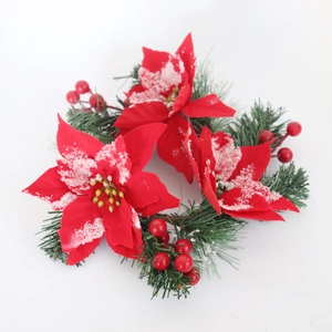 Red poinsettia Christmas wreath with snowy cedar needles and red berries on white background