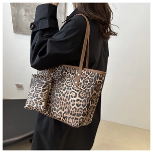 Detail shot of leopard print tote bag set featuring large shoulder bag and mini zipper pouch