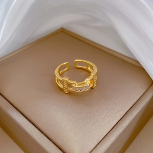Luxury gold plated adjustable ring with zircon stones on a premium silk background