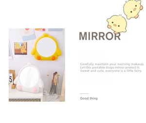 Detailed view of yellow and white cartoon chick makeup mirrors for desk or wall mounting