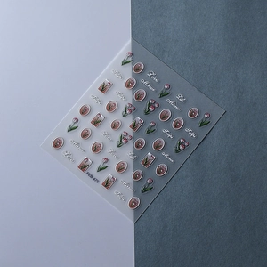 Macro shot of 5D embossed nail stickers featuring tulip flowers and vintage mirror frames