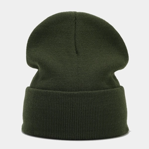 Close-up of dark green ribbed knit texture and folded cuff on a warm winter beanie