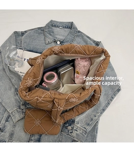 Top view of spacious brown quilted tote bag showing interior storage capacity and floral embroidery