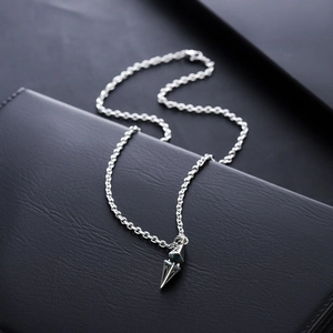 Close-up of vintage silver starburst pendant necklace on a premium black leather background