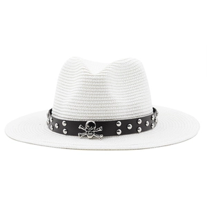 White straw fedora hat with black leather rivet belt and silver skull emblem for outdoors
