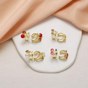 Set of four 18k gold plated cherry ear cuffs with red gems and pearls on silk fabric