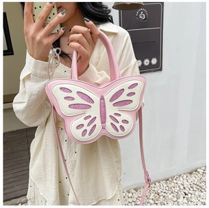 Pink butterfly-shaped handbag with white cutout wings and purple glitter accents