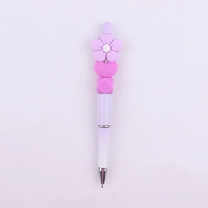 Detail of purple gradient beaded pen featuring a silicone flower and heart-shaped beads