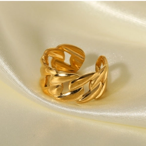 Detail of an 18K gold plated chain link adjustable ring on beige silk background