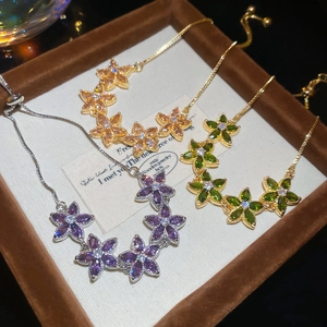 Detail of colorful flower bracelets with zircon inlay and adjustable sliding chain