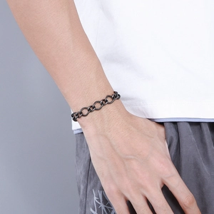 Close-up of a masculine 10mm twisted chain bracelet in vintage dark grey stainless steel