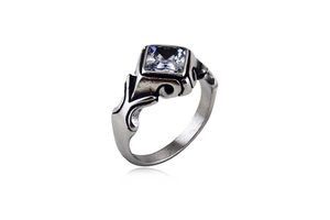 Macro detail of vintage stainless steel ring with square gemstone and engraved patterns