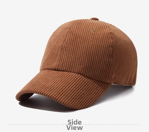 Close-up detail of brown corduroy fabric and vertical stripes on the baseball cap
