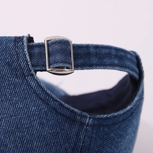 Detail of adjustable metal buckle and denim fabric on the kids vintage baseball cap