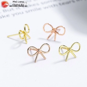 Detailed view of 925 sterling silver butterfly stud earrings in gold and rose gold tones