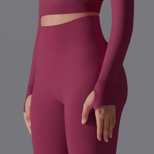 Detail of wine red seamless yoga set featuring thumbhole sleeves and ribbed high waist
