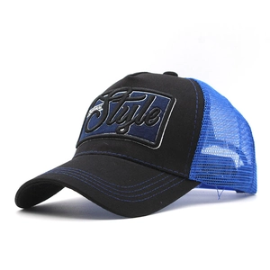 Side view detail of the 3D embroidered Style patch on the blue mesh trucker baseball cap