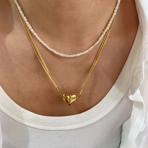 Double-layered gold snake chain necklace with pearl strand and a 3D heart pendant