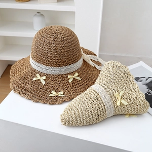 Handwoven straw sun hats with wavy brims, lace details and decorative bows for beach trips