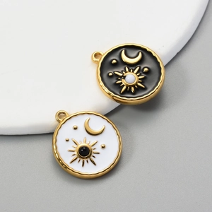 Gold stainless steel sun and moon tarot charms with black and white enamel details