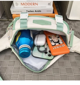 Top-down view of spacious interior storage in an off-white and green crossbody bag