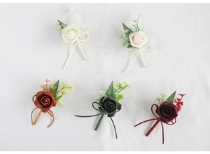 Detail of handmade PE rose boutonnieres in five colors with green leaves and ribbon bows
