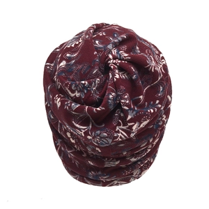 Detail of vintage floral print on soft burgundy knit slouchy beanie for autumn wear