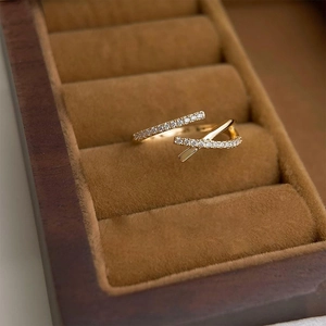 French style gold plated cross ring with pavé zircons displayed on a premium brown velvet tray