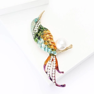 Exquisite peacock bird brooch with colorful enamel, sparkling crystals, and large pearl detail