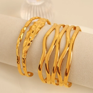 Gold plated titanium steel layered wave bangle with hammered texture finish