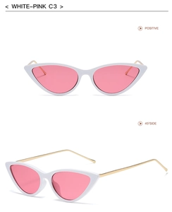 Detail view of white cat eye sunglasses with pink lenses and gold metal temples