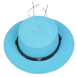 Detailed top view of bright blue straw hat with silver bull head and leather band