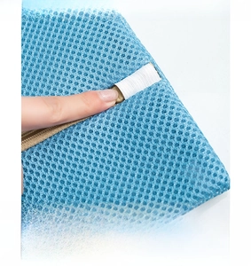 Detail of blue mesh laundry bag zipper guard preventing clothes from snagging