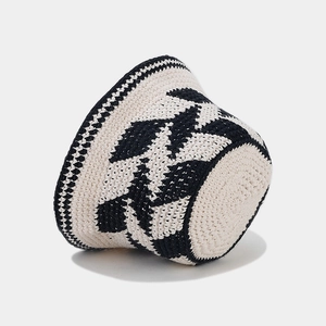 Handmade crochet cotton bucket hat with black geometric pattern and checkered brim detail