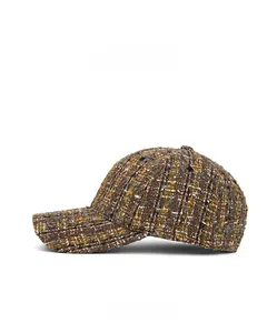 Side view detail of textured brown tweed baseball cap with vintage woven patterns