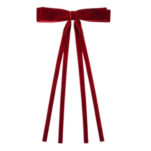 Detailed view of red velvet bow hair clip with four long elegant flowing ribbons